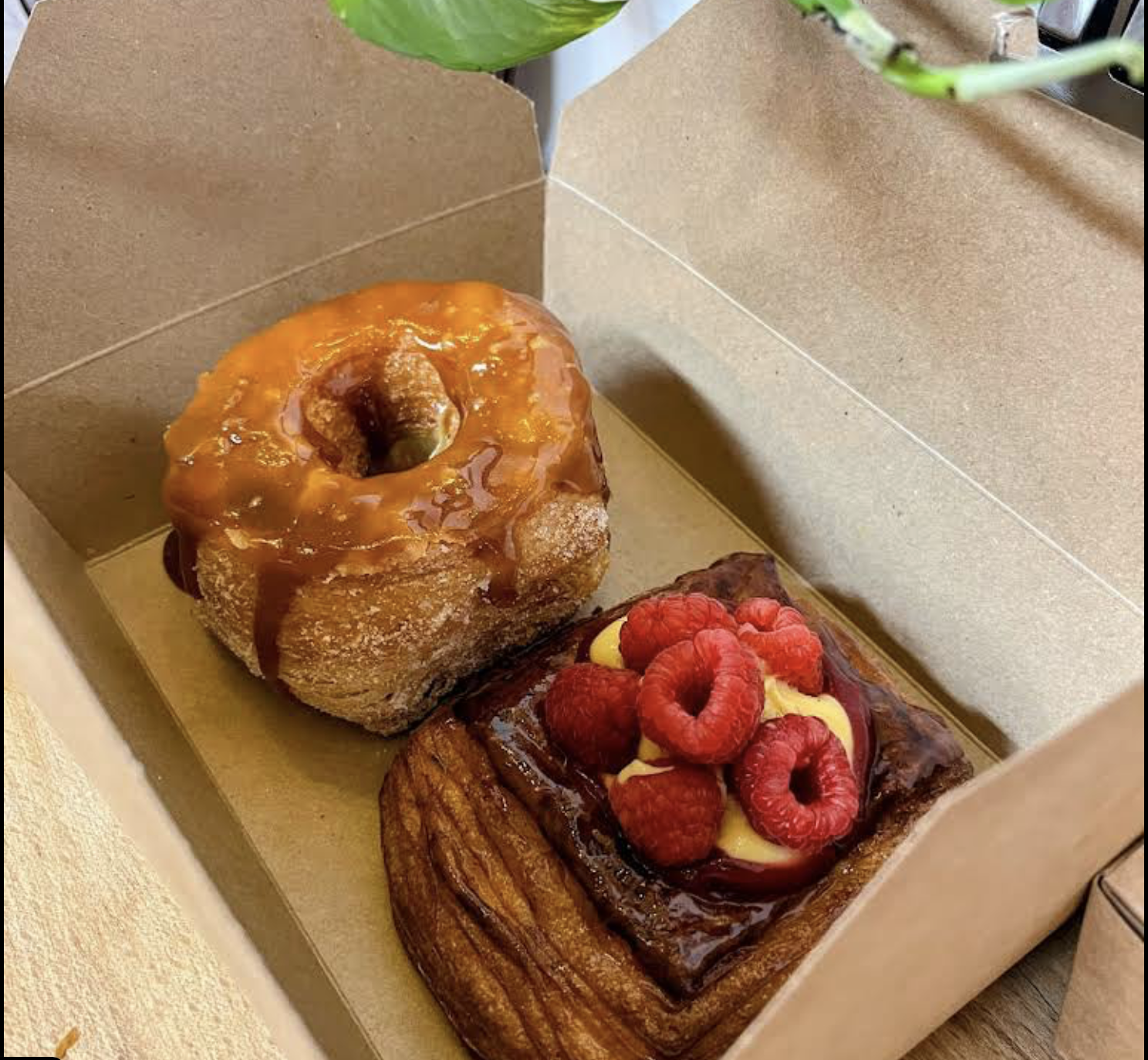 Cruffin and raspberry danish in a takeaway box